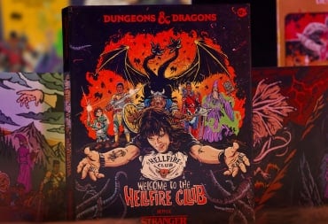 A game box showing a group of adventurers, a two-headed dragon, and a man in a black t-shirt with his arms outstretched.